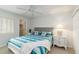 Bright bedroom with a ceiling fan, side tables, and a window letting in natural light at 150 Harborside Ave # 307, Punta Gorda, FL 33950