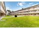 Inviting condo complex with well-maintained lawn, benches, and a grill for outdoor enjoyment at 150 Harborside Ave # 307, Punta Gorda, FL 33950