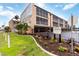 Condominium complex with landscaped garden and a sign indicating private drive and resident parking at 150 Harborside Ave # 307, Punta Gorda, FL 33950