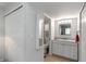 Hallway leads to a bathroom with a vanity and toilet, and a storage closet at 150 Harborside Ave # 307, Punta Gorda, FL 33950