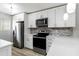 Well-equipped kitchen featuring stainless steel appliances and bright modern cabinetry at 150 Harborside Ave # 307, Punta Gorda, FL 33950