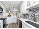 Bright kitchen with white cabinets, stainless appliances, and an island that overlooks the living area at 150 Harborside Ave # 307, Punta Gorda, FL 33950