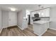 Updated kitchen featuring stainless steel appliances, white cabinetry, and hardwood floors at 150 Harborside Ave # 307, Punta Gorda, FL 33950