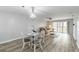 This living room offers a ceiling fan, dining table and chairs, with a sliding glass door for outdoor access at 150 Harborside Ave # 307, Punta Gorda, FL 33950