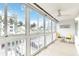 Lovely sunroom with tiled floor, and walls of windows showing tropical view at 150 Harborside Ave # 307, Punta Gorda, FL 33950
