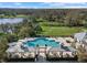 Aerial view of community pool area, landscaping, outdoor kitchen, and lounge space at 1539 Ormond Ter, Parrish, FL 34219