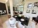 An elegant dining room features a modern chandelier, dark table, and decor at 1539 Ormond Ter, Parrish, FL 34219