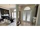 Elegant dining area with a modern chandelier, stylish decor, and ample natural light, perfect for hosting gatherings at 1539 Ormond Ter, Parrish, FL 34219