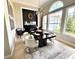 This dining room features a modern chandelier, a large window, and a fireplace with luxurious seating at 1539 Ormond Ter, Parrish, FL 34219