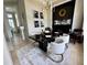 Modern dining room featuring a chic chandelier, stylish decor, and a sleek black accent wall with fireplace at 1539 Ormond Ter, Parrish, FL 34219