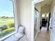 View of a hallway showcasing a window seat and bathroom with a walk-in shower at 1539 Ormond Ter, Parrish, FL 34219