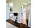 Hallway leading to a well-lit bathroom and living room, showcasing seamless transitions at 1539 Ormond Ter, Parrish, FL 34219