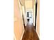 Hallway with wood floors leading to a bedroom with a view and black out curtains at 1539 Ormond Ter, Parrish, FL 34219