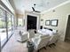 Spacious living room with large windows, a built-in entertainment center, and luxurious white furniture at 1539 Ormond Ter, Parrish, FL 34219