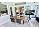 Covered patio has outdoor dining and lounge seating area plus a view of the home's interior at 1539 Ormond Ter, Parrish, FL 34219