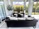 Covered patio with comfortable seating and views of the lush backyard at 1539 Ormond Ter, Parrish, FL 34219