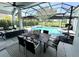 Screened patio area features outdoor dining and lounge furniture with a pool and water view at 1539 Ormond Ter, Parrish, FL 34219