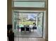 Covered patio featuring a dining table that sits adjacent to a screened in pool and water view at 1539 Ormond Ter, Parrish, FL 34219