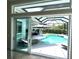 Covered patio with chaise lounge seating overlooking a private screened in pool and yard at 1539 Ormond Ter, Parrish, FL 34219