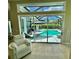 Poolside view through sliding doors showcasing the screened-in pool area at 1539 Ormond Ter, Parrish, FL 34219