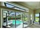 Relaxing screened-in pool and spa area with lounge chairs and beautiful lake views at 1539 Ormond Ter, Parrish, FL 34219