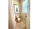 Small toilet room with framed artwork, a toilet, and natural light from the window at 1539 Ormond Ter, Parrish, FL 34219