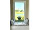 Charming window seat with decorative pillows overlooking a serene lake view at 1539 Ormond Ter, Parrish, FL 34219