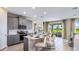 Bright modern kitchen featuring gray cabinets, stainless steel appliances, and a large island with seating at 17924 Tavernside Trl, Bradenton, FL 34211