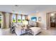 Spacious living room featuring a large window, a modern couch, and neutral décor at 17924 Tavernside Trl, Bradenton, FL 34211