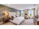 Serene main bedroom features a decorative wall, plush carpet, and abundant natural light from multiple windows at 17924 Tavernside Trl, Bradenton, FL 34211
