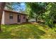 Backyard view of detached storage shed and yard with mature foliage at 1862 Rita St, Sarasota, FL 34231