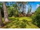 Backyard view with shade trees, showcasing the spacious, grassy area at 1862 Rita St, Sarasota, FL 34231