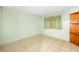 Calming bedroom with soft green walls, a practical shelving unit, and tile flooring at 1862 Rita St, Sarasota, FL 34231