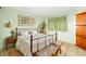 Serene bedroom showcasing a comfortable bed, soft green walls, and natural light at 1862 Rita St, Sarasota, FL 34231
