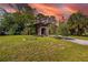 Charming single-story home featuring lush landscaping and a welcoming arched entryway at 1862 Rita St, Sarasota, FL 34231