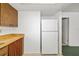 Kitchen with light countertops, wood cabinets, and a white refrigerator at 1862 Rita St, Sarasota, FL 34231