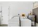 Functional laundry room with side-by-side washer and dryer units and a hot water tank at 1862 Rita St, Sarasota, FL 34231