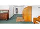 Open floorplan living room with vintage wooden furniture and green carpet at 1862 Rita St, Sarasota, FL 34231