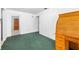 Open floorplan living room with vintage wooden furniture and green carpet at 1862 Rita St, Sarasota, FL 34231