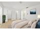 Bright main bedroom with ensuite bathroom and walk-in closet, complete with calming neutral tones and tile flooring at 1862 Rita St, Sarasota, FL 34231