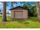 Image of detached storage shed, nestled among trees in the backyard at 1862 Rita St, Sarasota, FL 34231