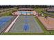 An aerial view featuring a basketball court, a tennis court, and playground near the pool area at 18620 Cortes Creek Blvd, Spring Hill, FL 34610