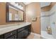 Bathroom featuring a vanity with a marble countertop, dark wood cabinets, and an open shower at 18620 Cortes Creek Blvd, Spring Hill, FL 34610