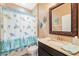 Charming bathroom with a turtle-themed shower curtain, decorative accents, and a granite-topped vanity at 18620 Cortes Creek Blvd, Spring Hill, FL 34610