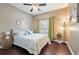 Bright bedroom featuring beach-themed bedding, hardwood floors, and a window with curtains at 18620 Cortes Creek Blvd, Spring Hill, FL 34610
