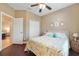 Cozy bedroom with beach-themed decor, ceiling fan, and hardwood floors at 18620 Cortes Creek Blvd, Spring Hill, FL 34610