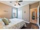 Cozy bedroom with ocean-themed wall decor, a ceiling fan, and hardwood floors at 18620 Cortes Creek Blvd, Spring Hill, FL 34610