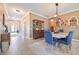 Open dining room features elegant blue chairs, a stylish light fixture, and a hutch for storage at 18620 Cortes Creek Blvd, Spring Hill, FL 34610