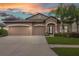 Charming single-Gathering home with a three-car garage, well-manicured lawn, and beautiful landscaping at 18620 Cortes Creek Blvd, Spring Hill, FL 34610