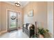 Inviting foyer with decorative tile flooring, elegant decor, and natural light from the glass front door at 18620 Cortes Creek Blvd, Spring Hill, FL 34610